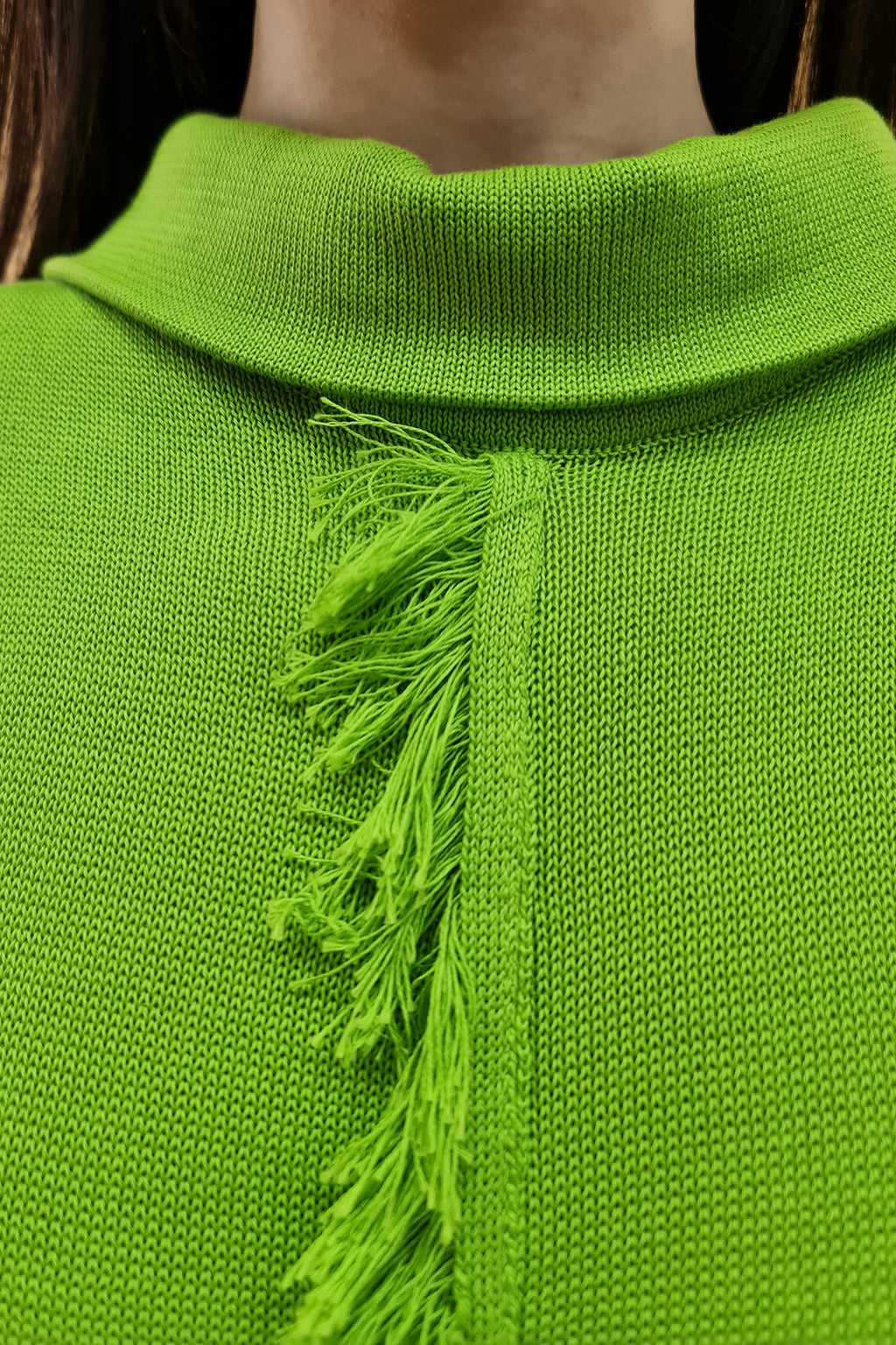 Green knit sweater with fringe detail on the front