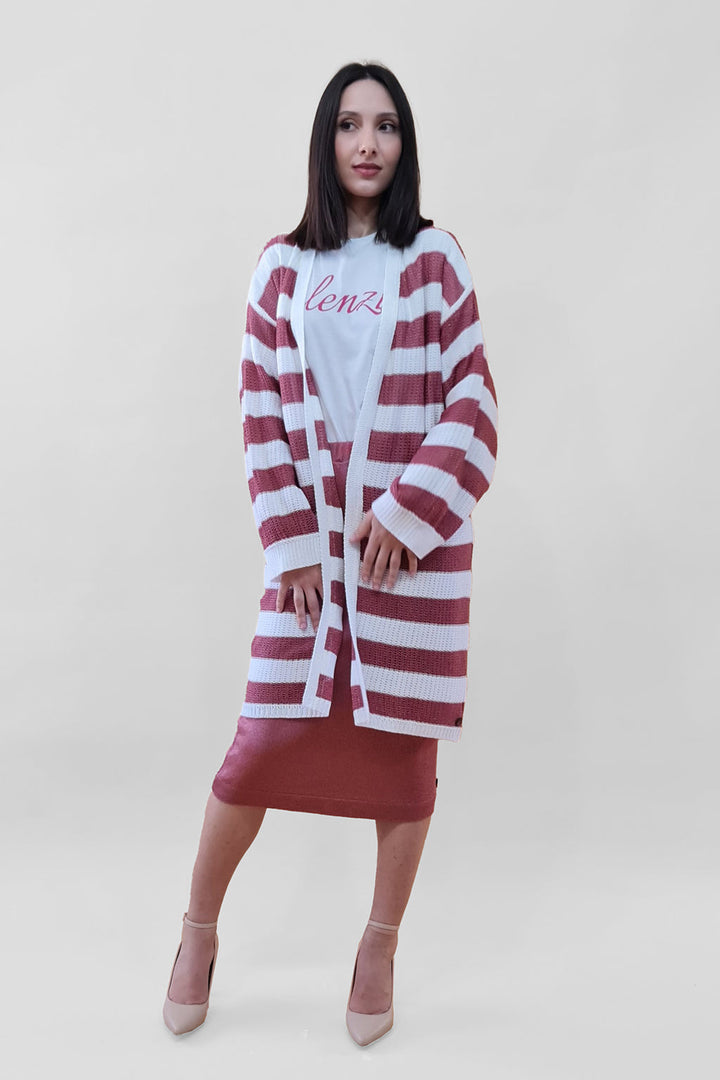 Woman wearing striped cardigan and skirt set against white background