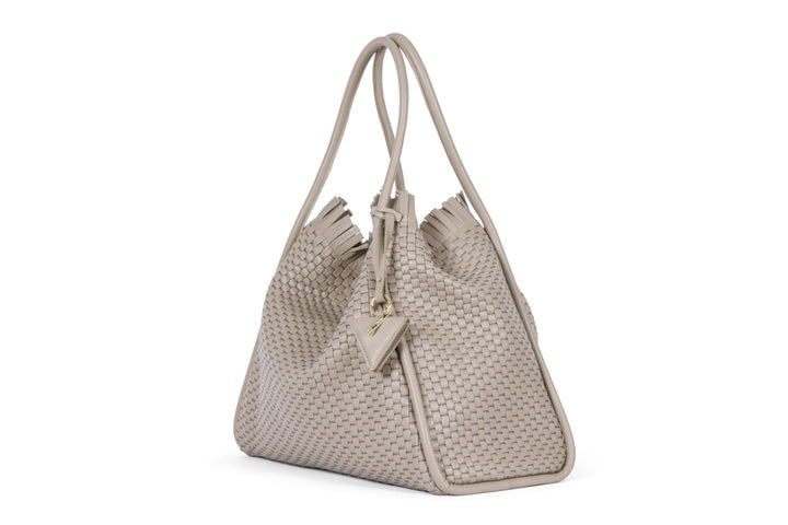 Beige woven leather tote bag with tassel and triangle charm