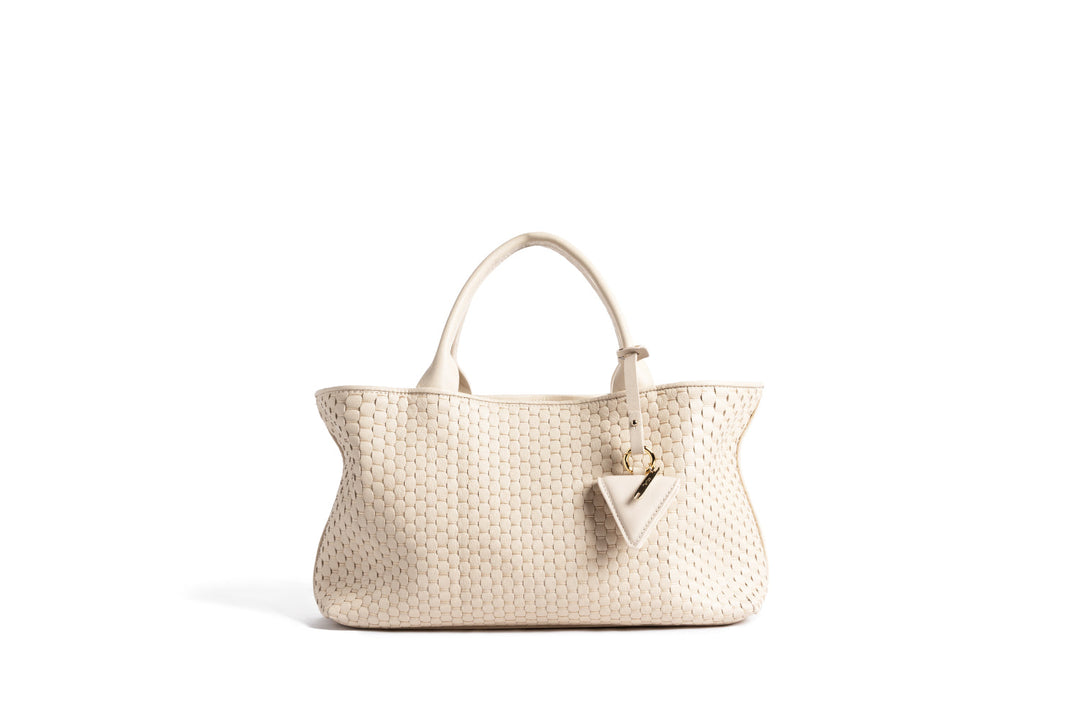 Beige woven tote handbag with gold accent against white background