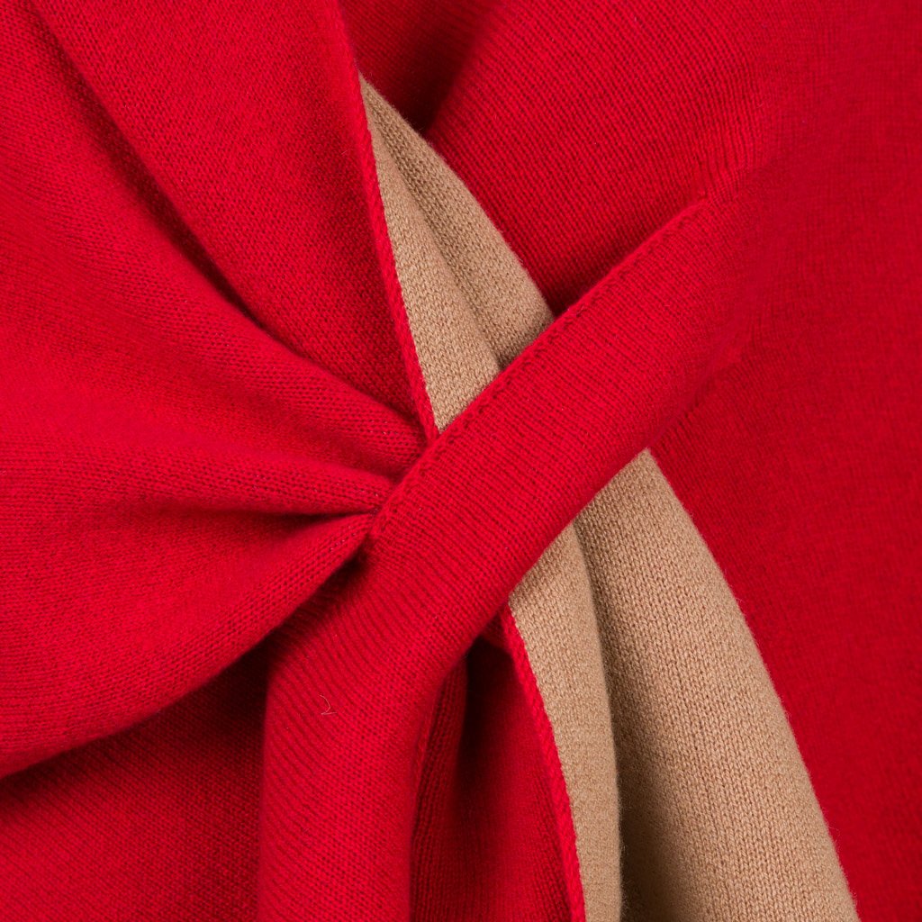 Close-up of red and beige knit fabric intertwined