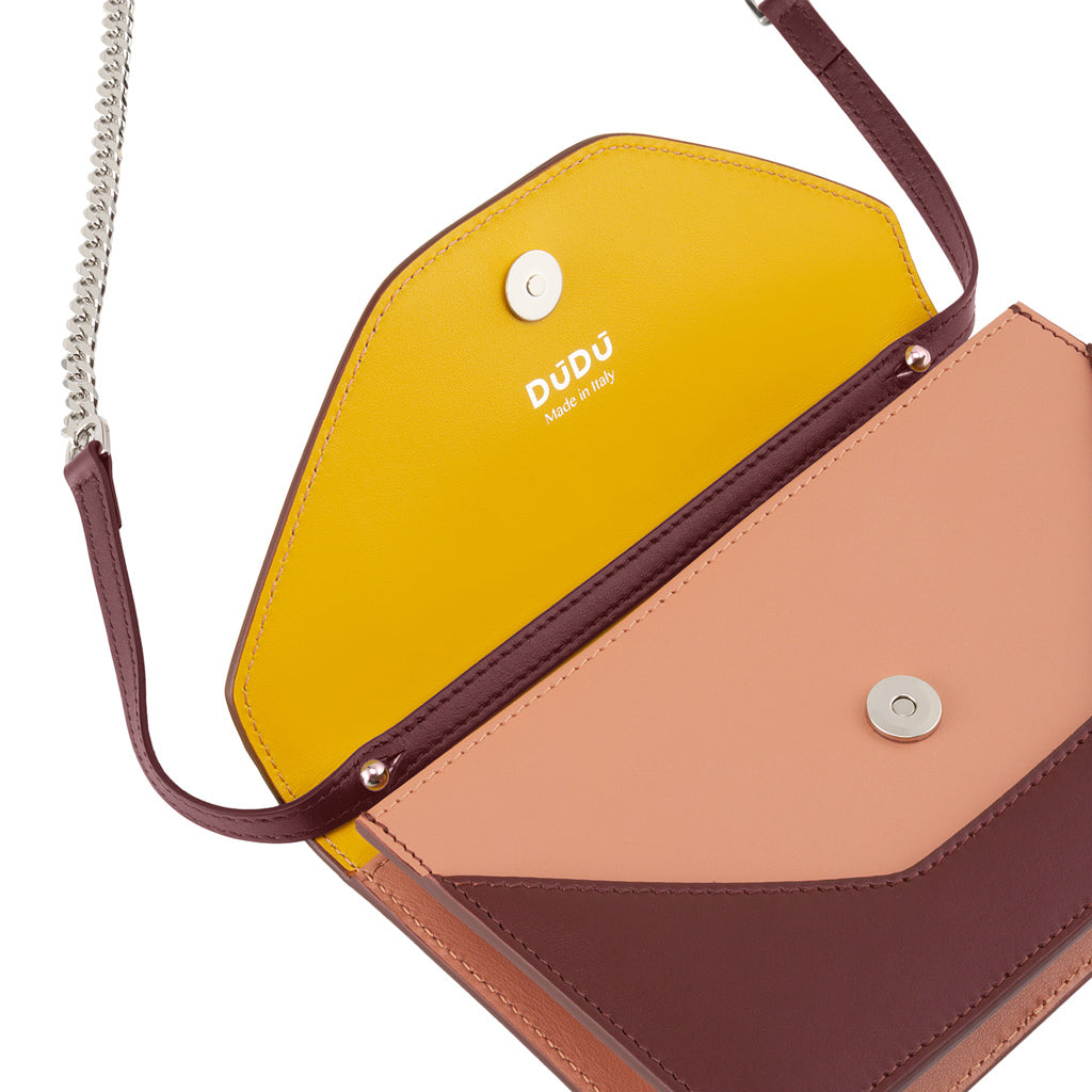 Colorful leather crossbody bag with chain strap and open yellow interior by DUDU
