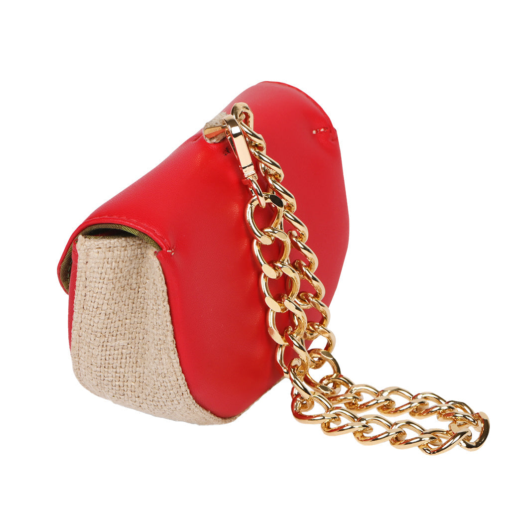 Red leather handbag with gold chain strap and beige fabric side panel