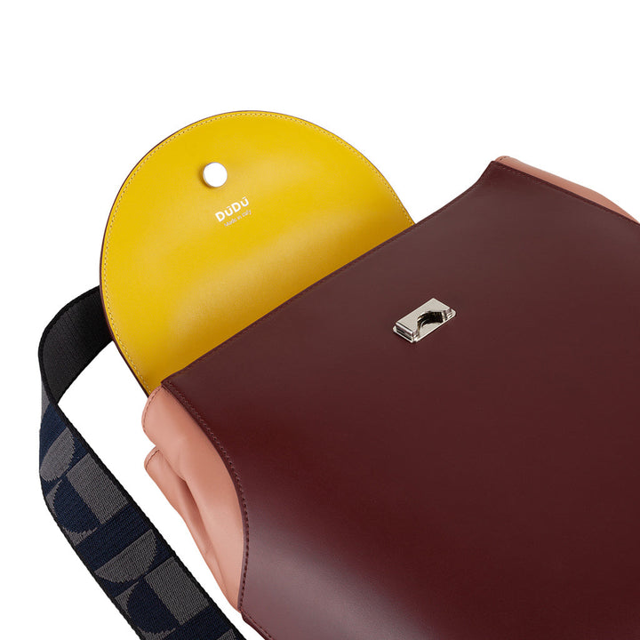 Two-tone leather shoulder bag with yellow inner flap and metal clasp