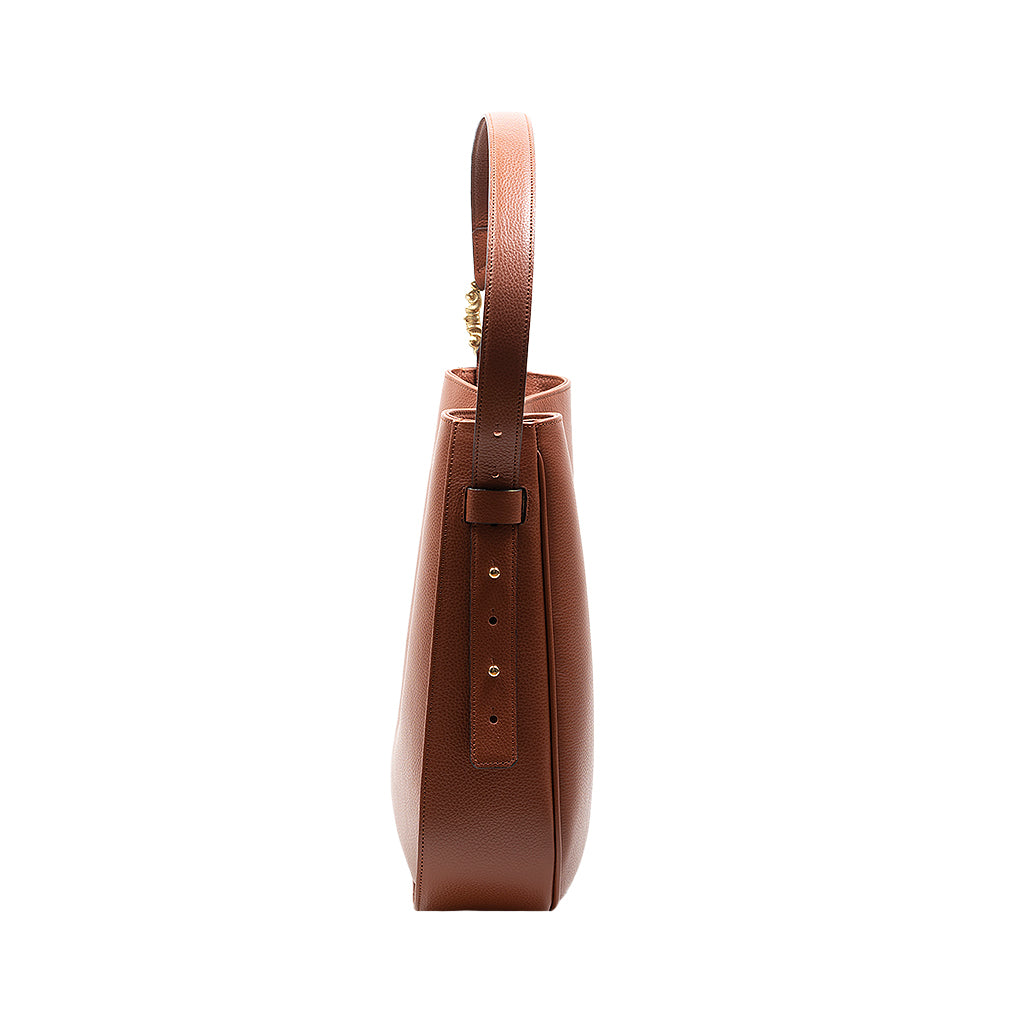 Side view of a brown leather handbag with a top handle