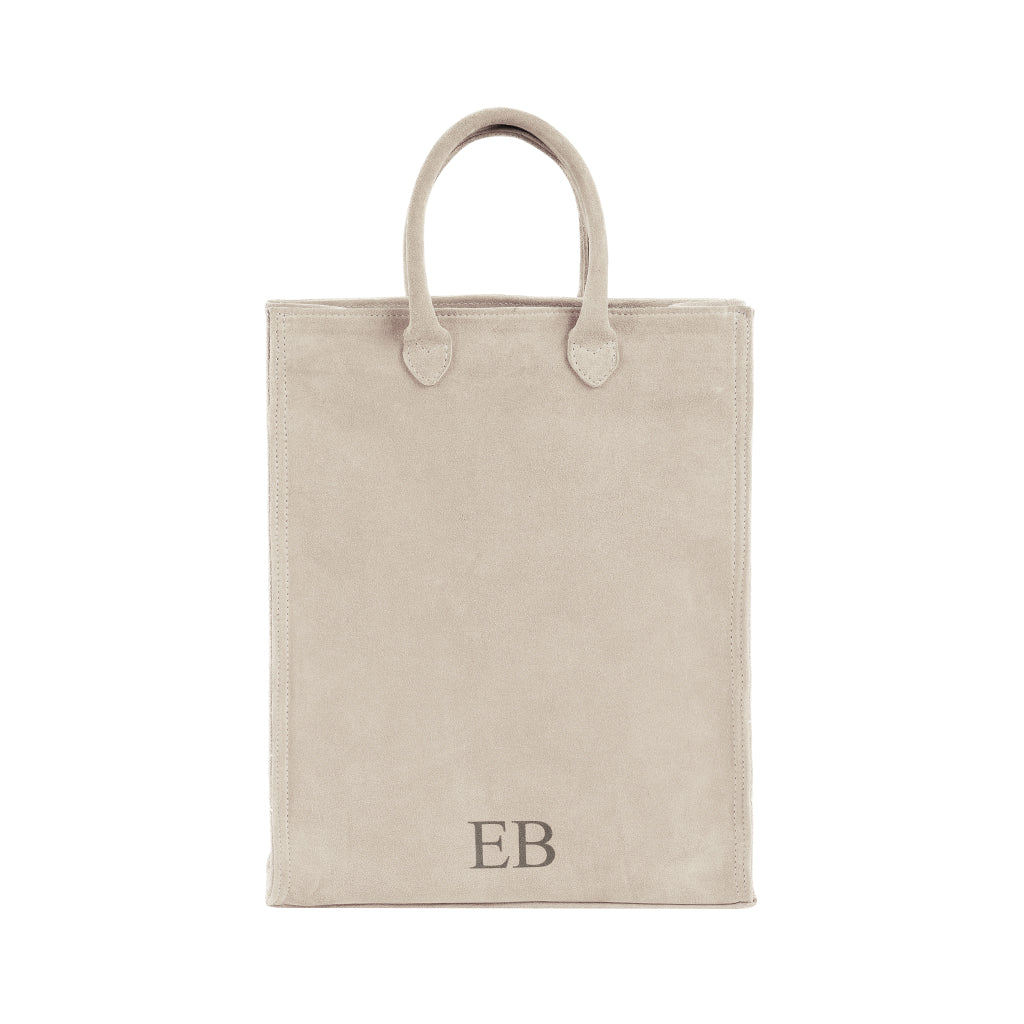 Beige suede tote bag with initials EB on the bottom