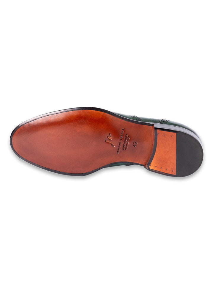 Bottom view of a leather dress shoe with brown sole and size marking