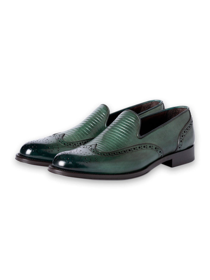 Green leather loafers with decorative detailing and low heels