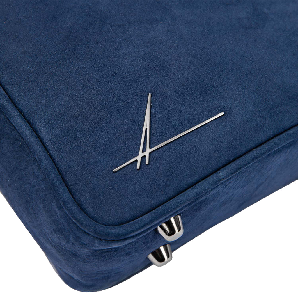 Blue suede cushion with silver metallic logo and zipper details