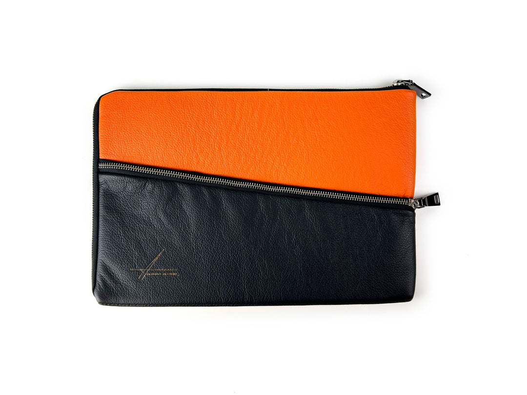 Modern two-tone leather laptop sleeve, black and orange with zipper closure