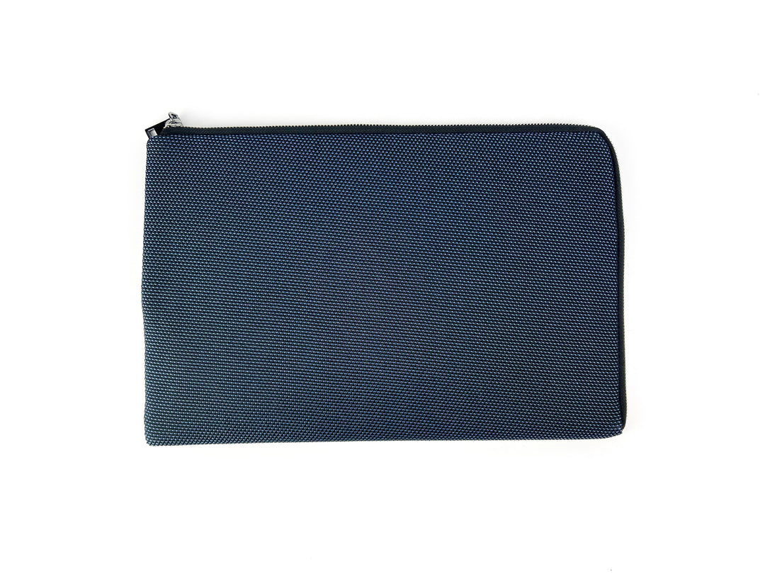 Blue textured zipper pouch on white background