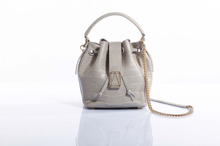 Elegant gray crocodile print handbag with gold chain strap and drawstring closure