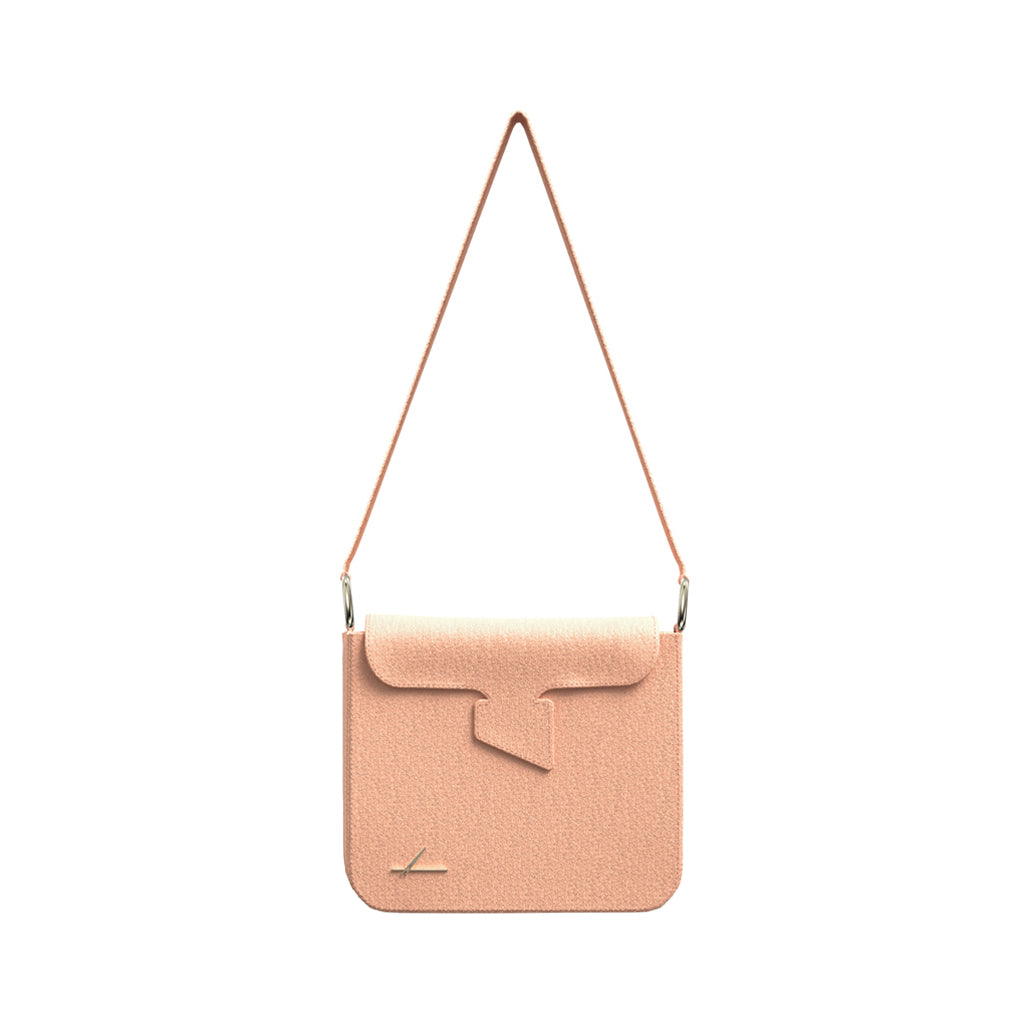 Elegant peach leather handbag with unique flap design and shoulder strap
