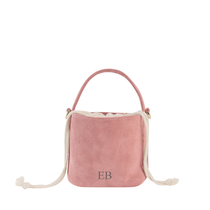 Pink suede bucket bag with rope handles and monogrammed initials EB on the front