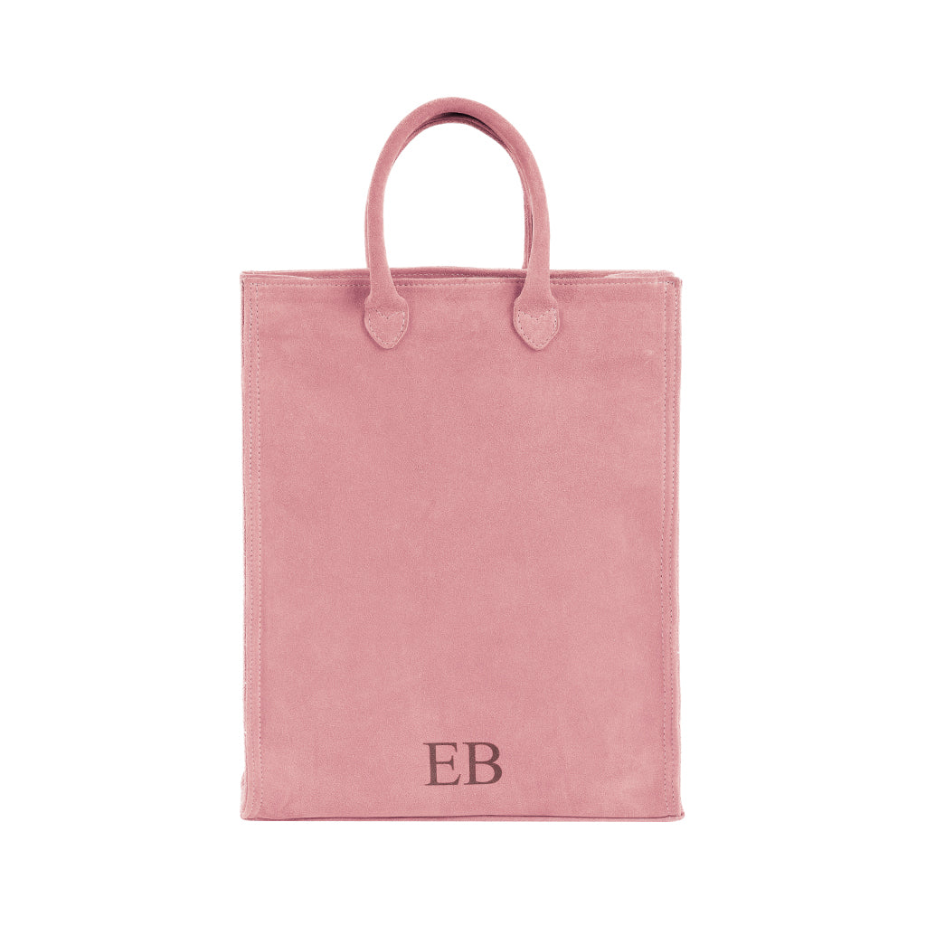 Pink suede tote bag with monogrammed EB initials on front