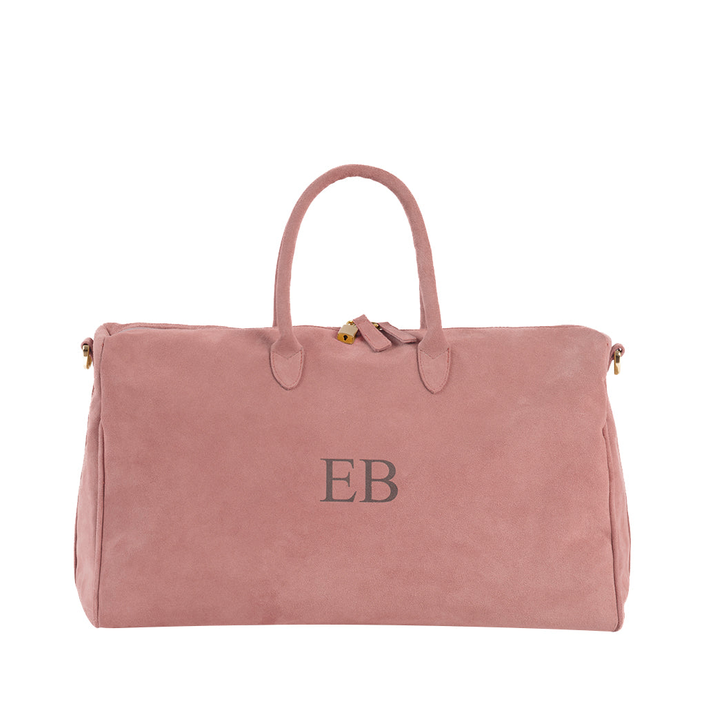 Pink leather duffel bag with monogram initials EB in the center