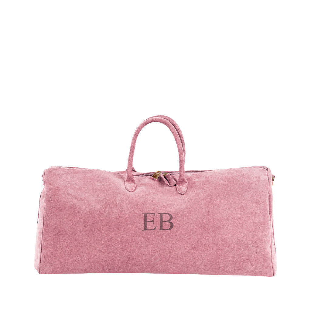 Pink suede duffle bag with initials 'EB' embroidered on front