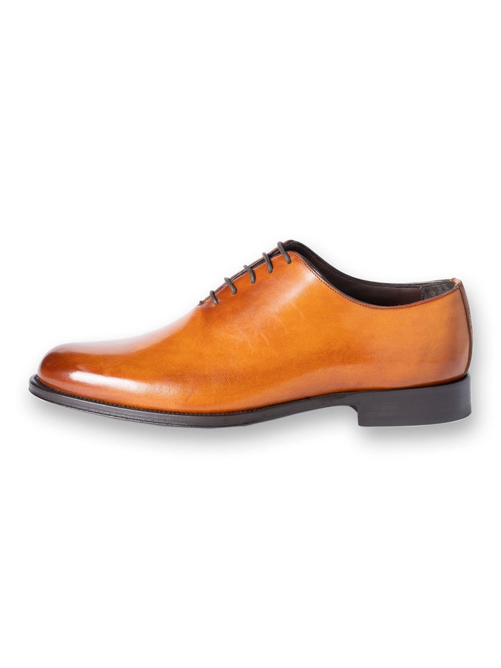 Tan leather dress shoe with sleek design and black laces