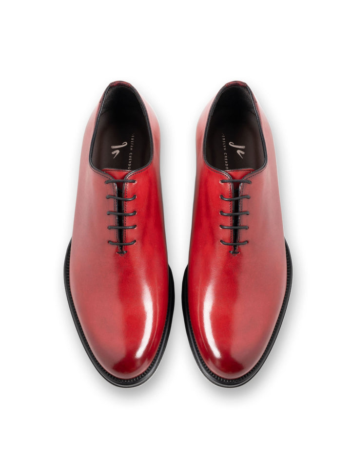 Red leather dress shoes with black laces, top view