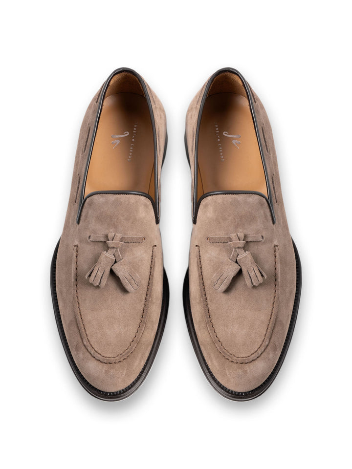 Beige suede tassel loafers for men with black soles, viewed from the top