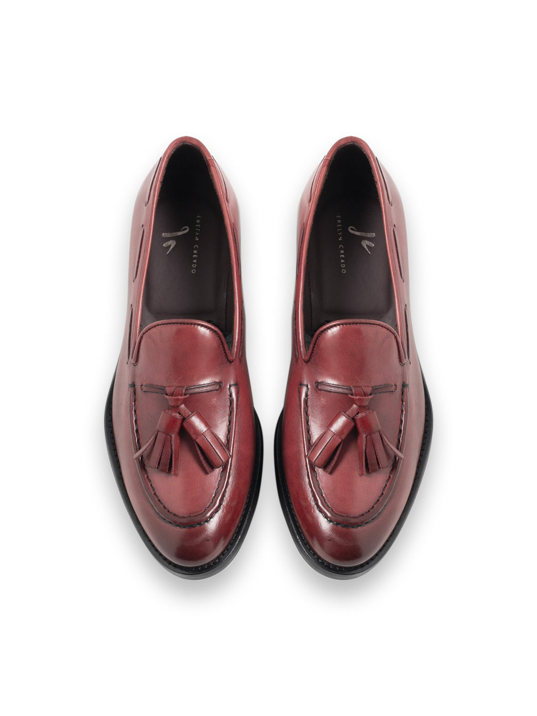 Burgundy leather tassel loafers for men on white background