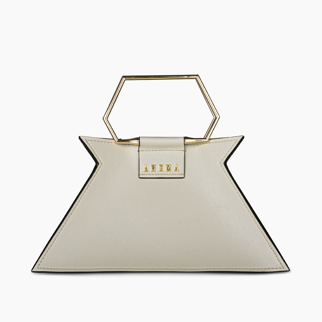 White geometric designer handbag with gold hexagonal handle