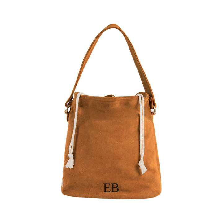 Brown suede bucket bag with drawstring closure and shoulder strap, featuring the initials 'EB'