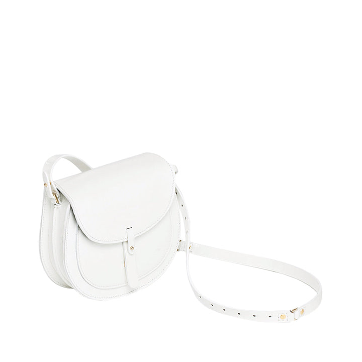 White leather crossbody bag with adjustable strap and flap closure