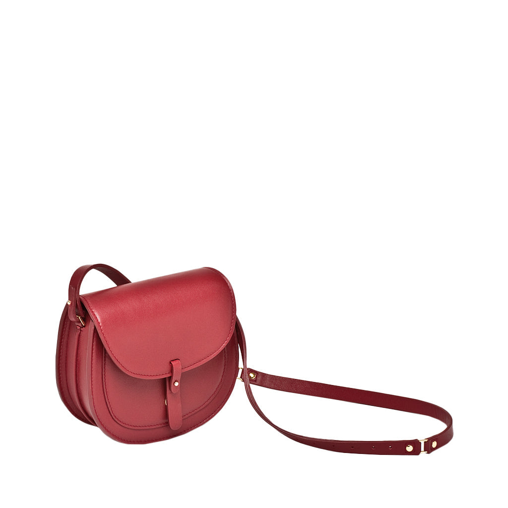 Red leather crossbody bag with adjustable strap and front buckle