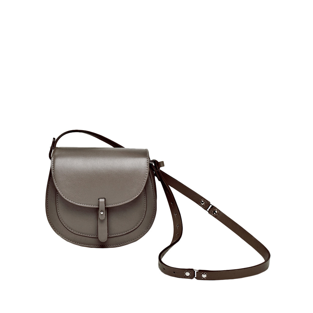 Gray leather crossbody bag with adjustable strap and front buckle