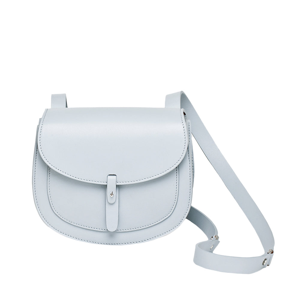 Light blue leather crossbody bag with adjustable strap and front flap