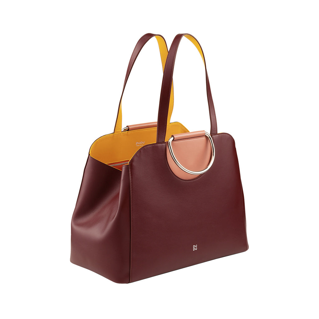 Elegant maroon leather tote bag with yellow and pink accents, and silver ring handles