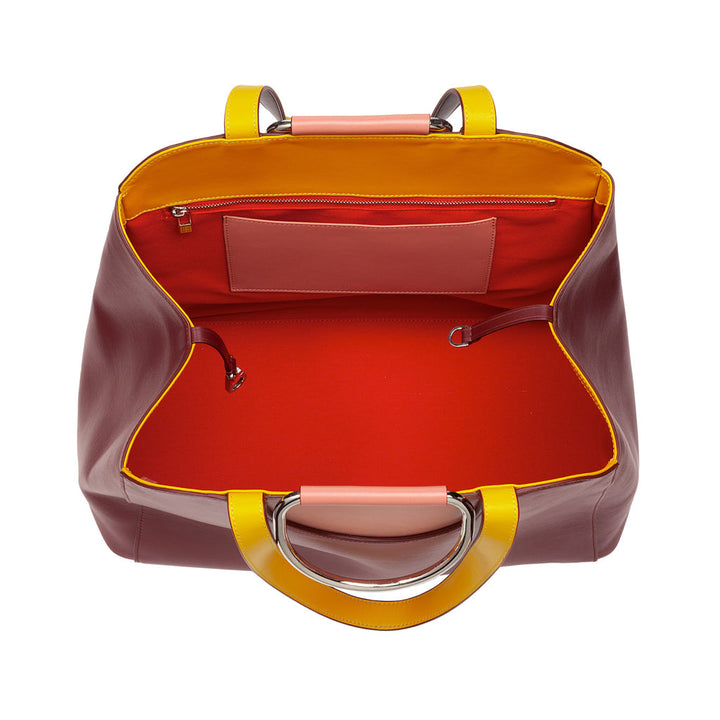 Open leather handbag with red interior, yellow handles, and inner zipper pocket