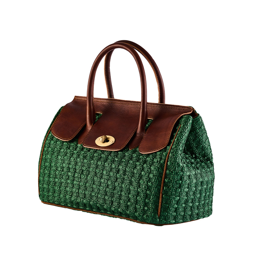 Green and brown woven handbag with leather handles and gold clasp