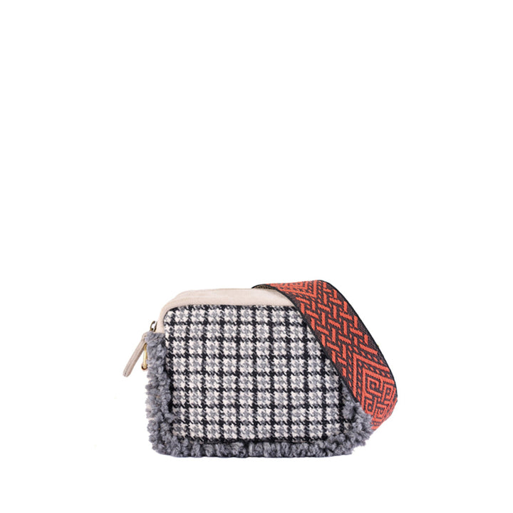 Plaid-patterned handbag with decorative red strap on white background