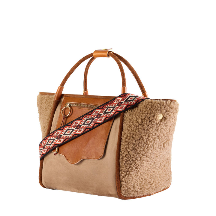 Stylish tan leather and shearling handbag with patterned strap