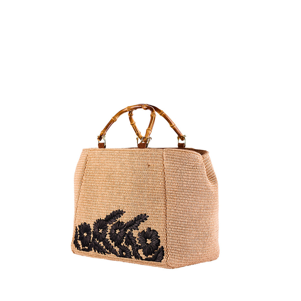 Elegant straw handbag with black floral embroidery and bamboo handles