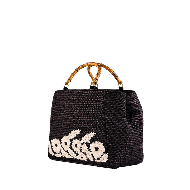 Elegant black woven handbag with bamboo handles and white floral embroidery