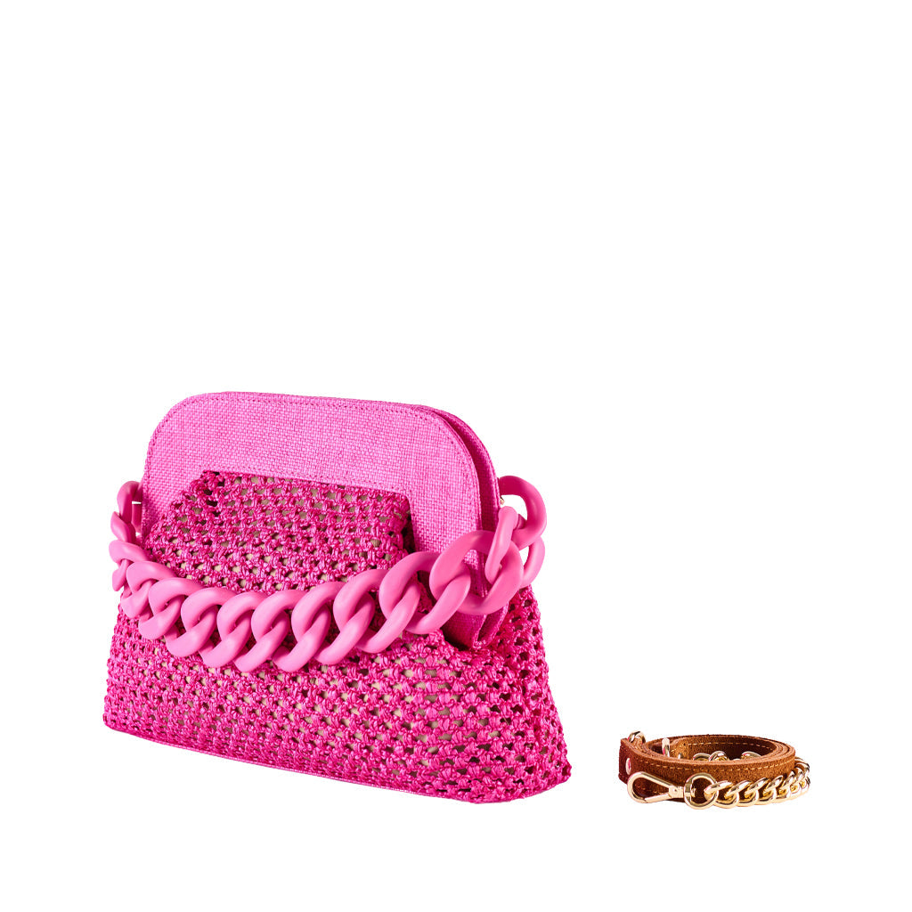 Pink woven handbag with oversized chain strap and brown leather bracelet on white background