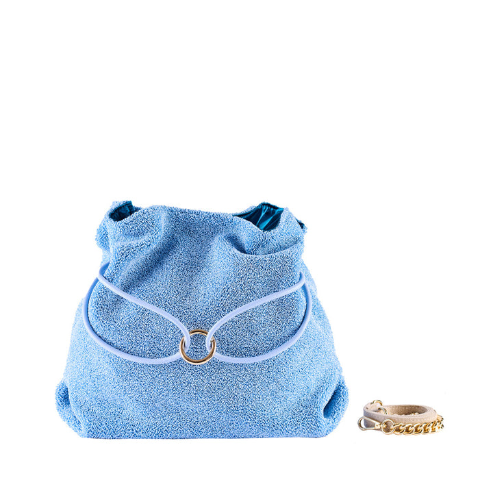 Light blue textured handbag paired with a beige and gold bracelet on a white background