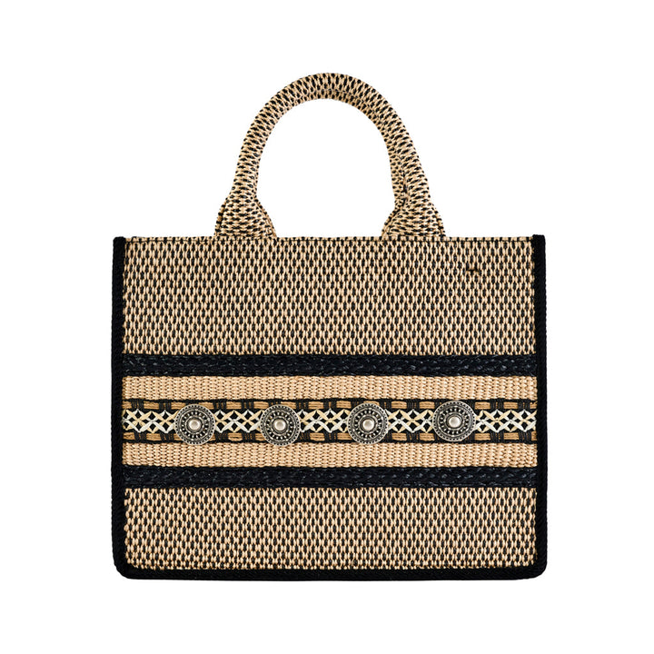 Handwoven natural fiber tote bag with geometric black and tan design and decorative accents