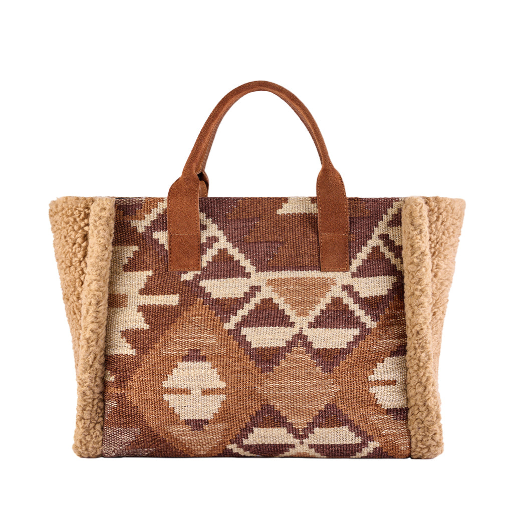 Geometric patterned tote bag with leather handles and faux shearling trim