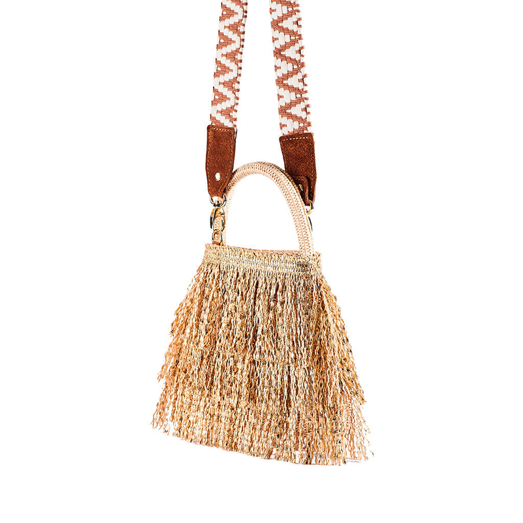 Handwoven boho-style handbag with fringe and patterned strap