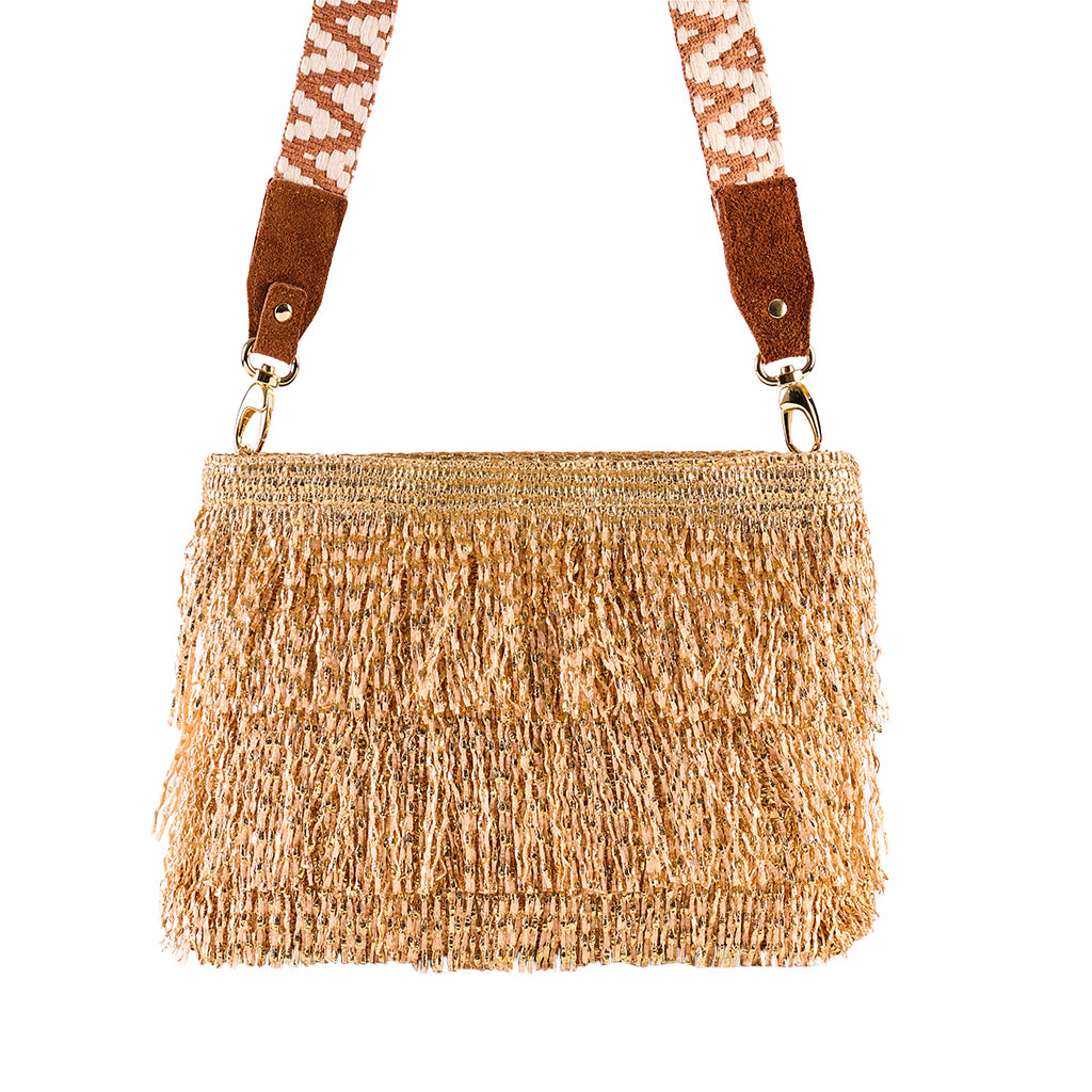 Woven straw handbag with decorative fringe and patterned strap