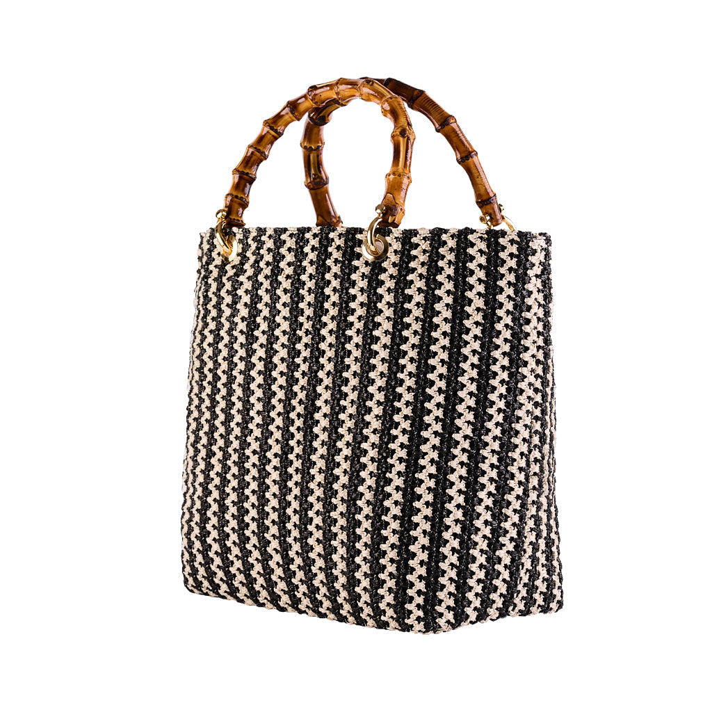 Black and white woven handbag with bamboo handles