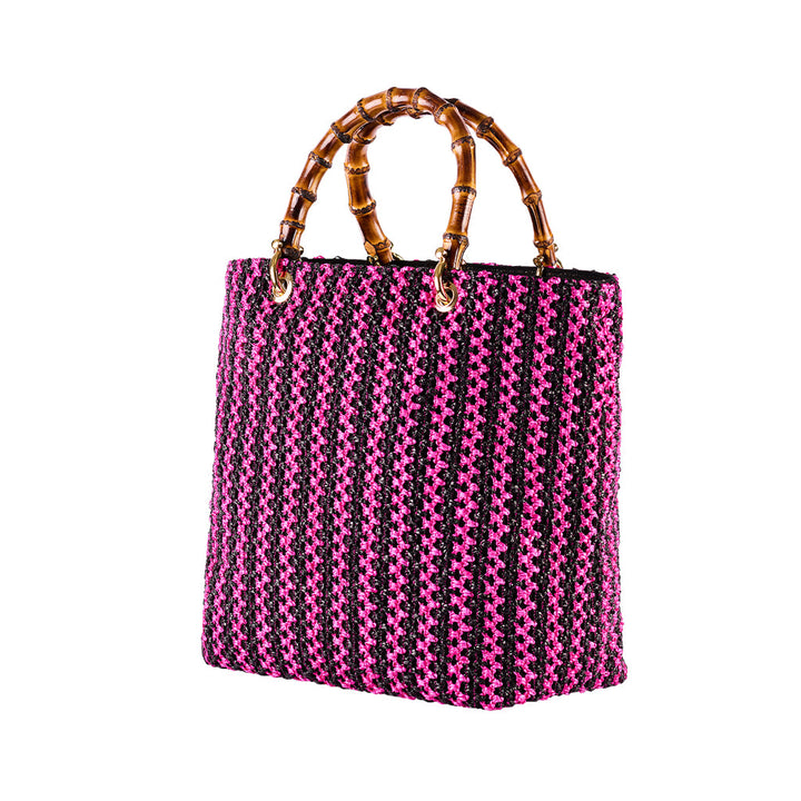 Pink and black woven handbag with bamboo handles