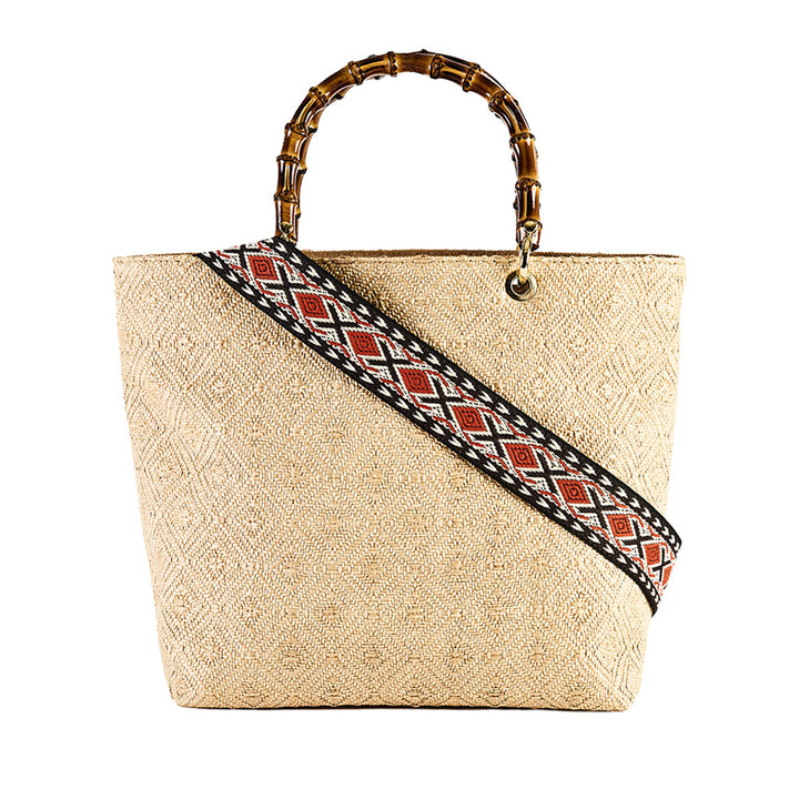 Woven straw handbag with bamboo handle and decorative patterned strap