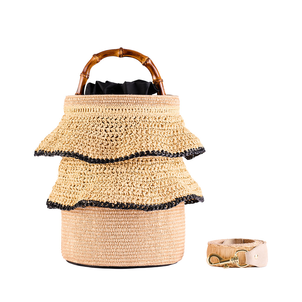 Handcrafted woven straw bag with bamboo handle and matching wristband