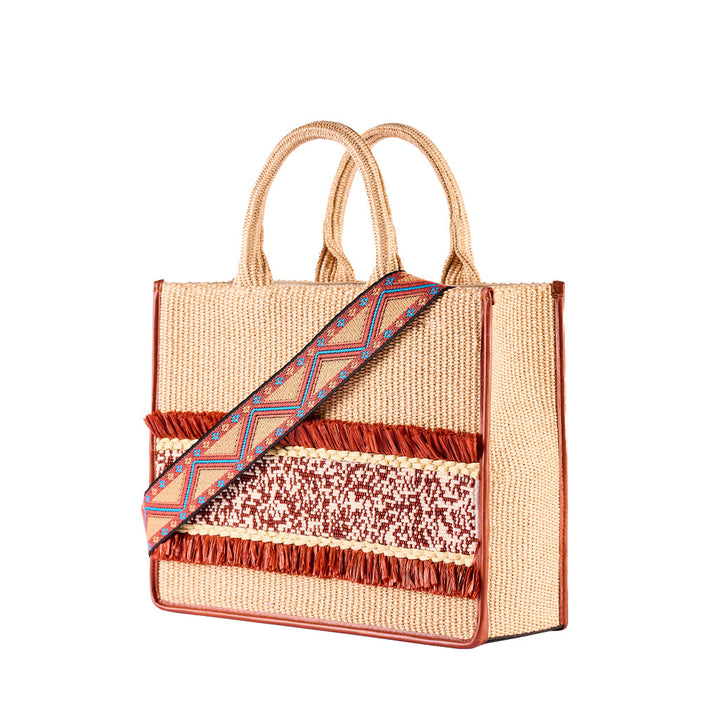 Handwoven beach tote bag with vibrant decorative strap and fringe detailing