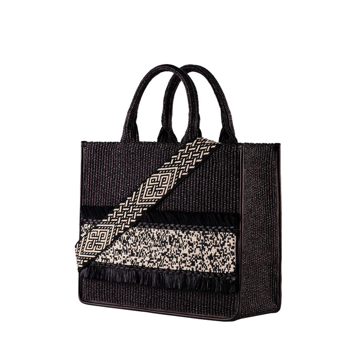 Black woven handbag with intricate geometric patterns and dual handles